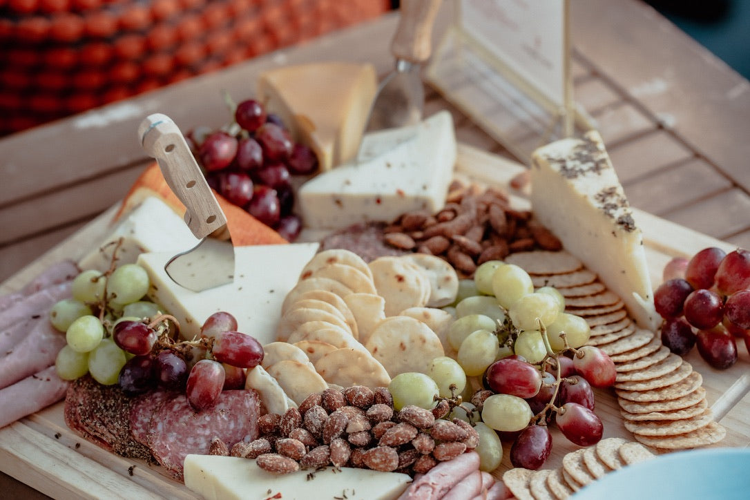 Charcuterie board with cheese, grapes, and crackers